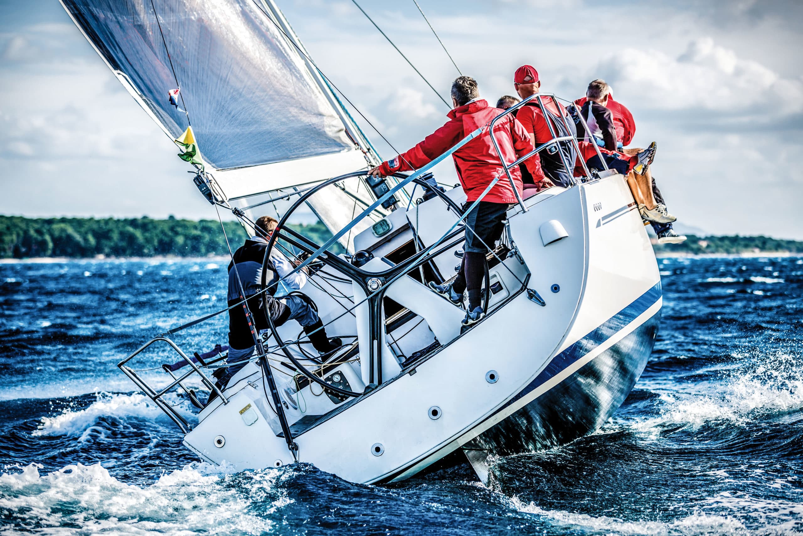 Sailing crew on sailboat during regatta